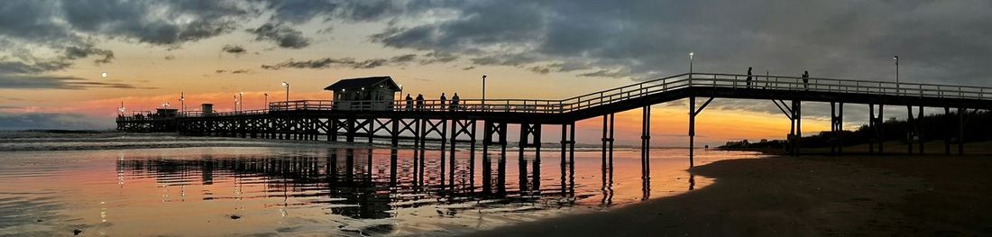 Silhouette of pier at sunset