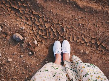 Low section of woman standing on tiled floor