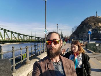 Portrait of man with against sky in city