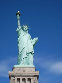 Low angle view of statue against blue sky