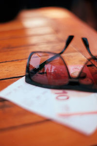 Close-up of sunglasses on wooden surface