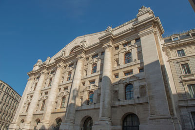 Low angle view of building against blue sky