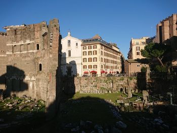 Buildings against clear blue sky in city