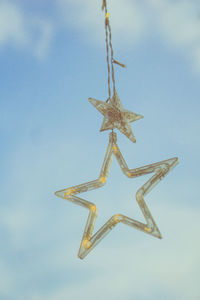 Low angle view of christmas decoration hanging against sky