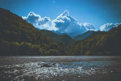 Scenic view of lake and mountains against sky