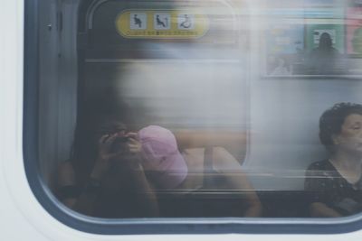 Woman looking through train window