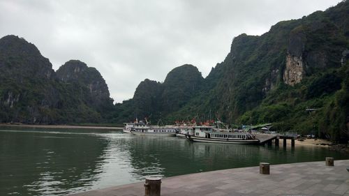 Scenic view of river amidst mountains against sky