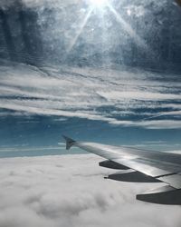 Airplane wing over cloudscape