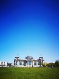 Buildings against clear blue sky