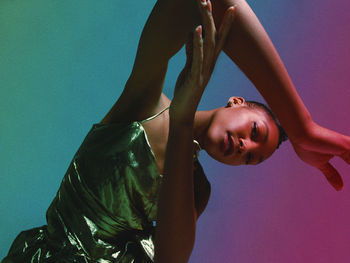 Portrait of woman against colored background