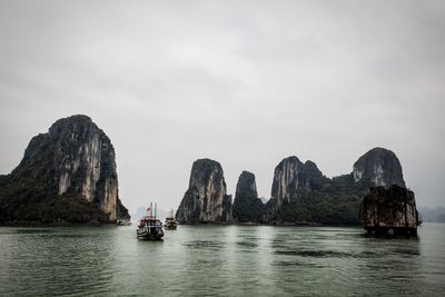 Scenic view of rocks in sea against sky