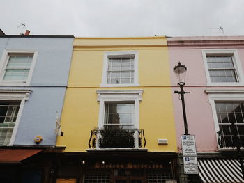 Low angle view of yellow building against sky