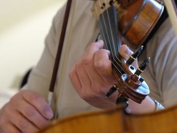 Midsection of man playing violin