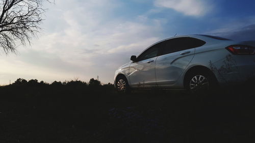 Car on field against sky