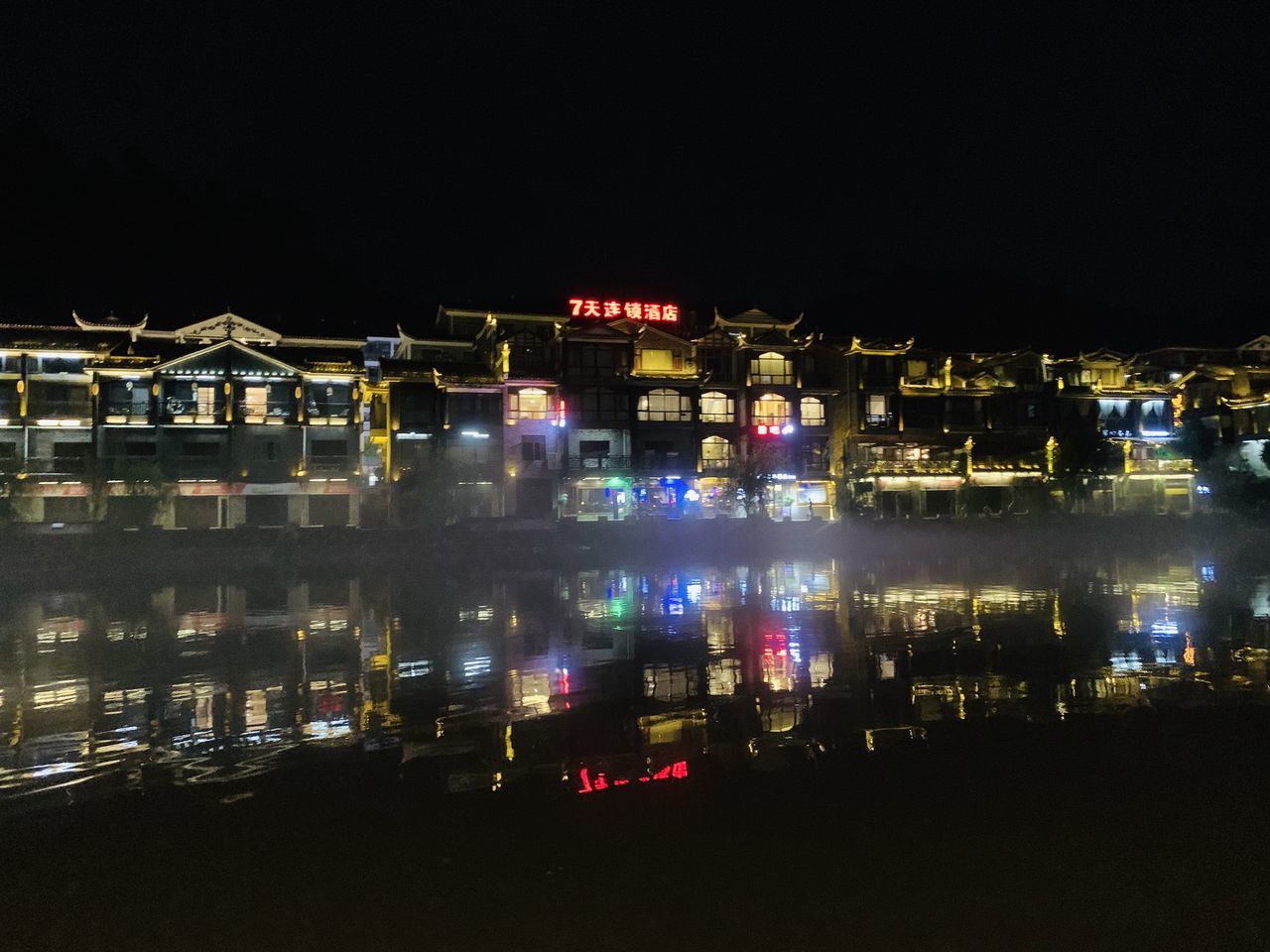 ILLUMINATED BUILDINGS AGAINST SKY AT NIGHT