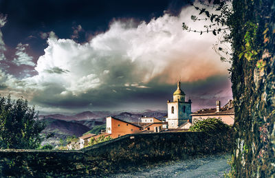 Panoramic view of buildings and trees against sky