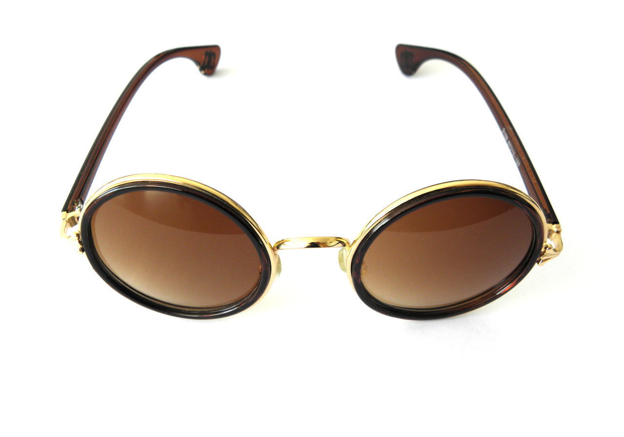 CLOSE-UP OF SUNGLASSES AGAINST SKY OVER WHITE BACKGROUND