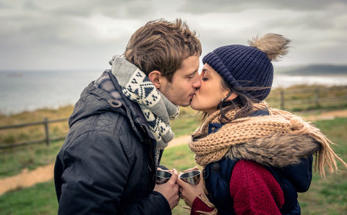 Side view of couple kissing in winter