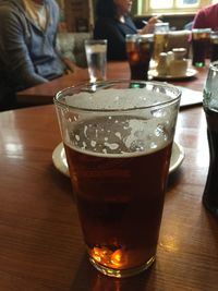 Close-up of beer glass on table