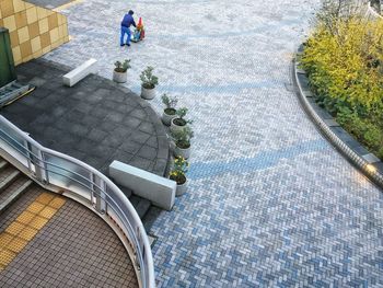 High angle view of man sitting by swimming pool