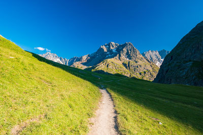 Scenic view of mountains against clear blue sky