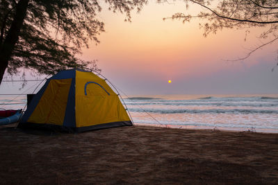 Scenic view of beach against sky during sunset