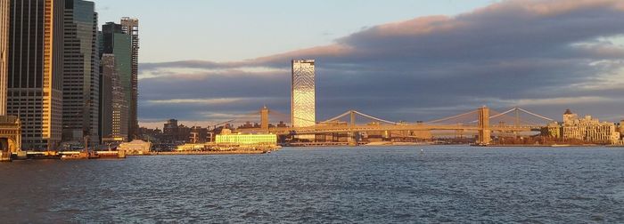 Bridge over river with buildings in background