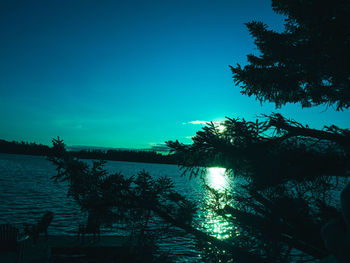 Scenic view of lake against clear sky at sunset