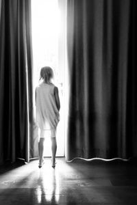 Rear view of boy standing in corridor