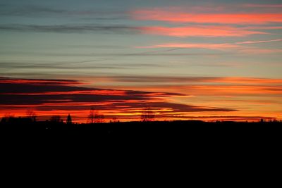 Silhouette landscape against sky during sunset