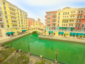 High angle view of swimming pool by buildings against sky