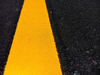 High angle view of yellow line on road