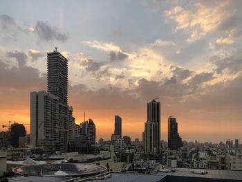 Modern buildings in beirur city against sky during sunset