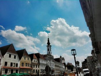 Low angle view of buildings against cloudy sky