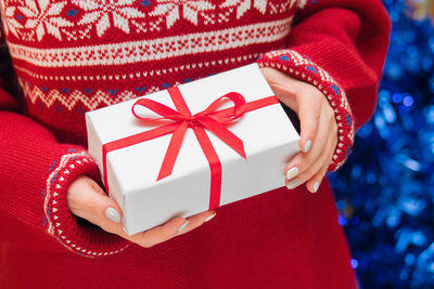 Midsection of woman holding gift box during christmas