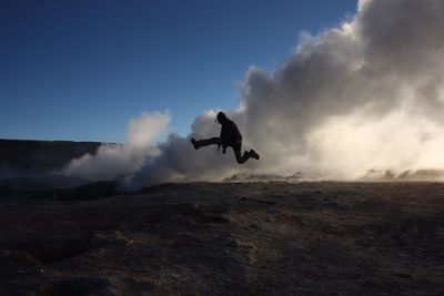 Man jumping against sky