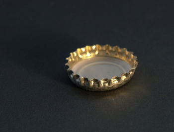 Close-up of illuminated lighting equipment on table against black background