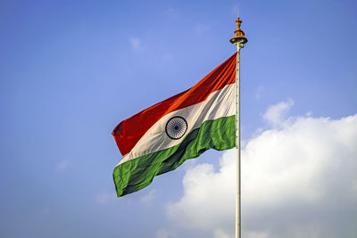 Indian national flag , flying high in the sky on a beautiful , clear blue sky background.