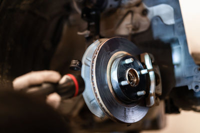 Close-up of man working on machine