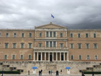 Greek parliament against cloudy sky