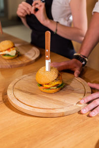 Midsection of woman with cake on table