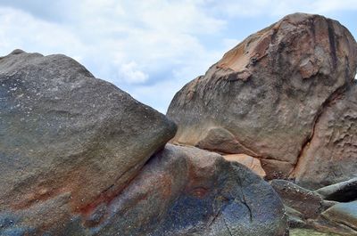 Low angle view of rock formation against sky