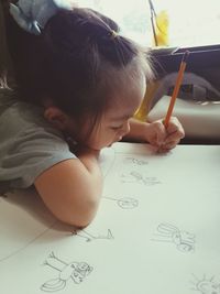 Girl drawing on paper
