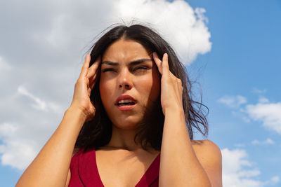 Portrait of beautiful woman against sky