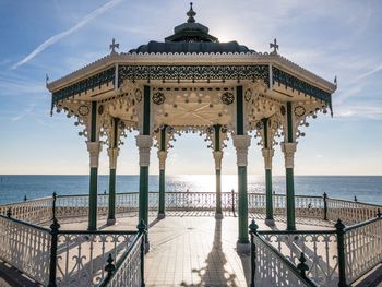 Gazebo by sea against sky