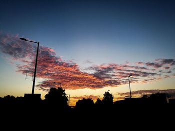 Low angle view of silhouette trees against sky during sunset