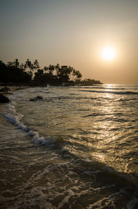 Scenic view of sea against clear sky at sunset