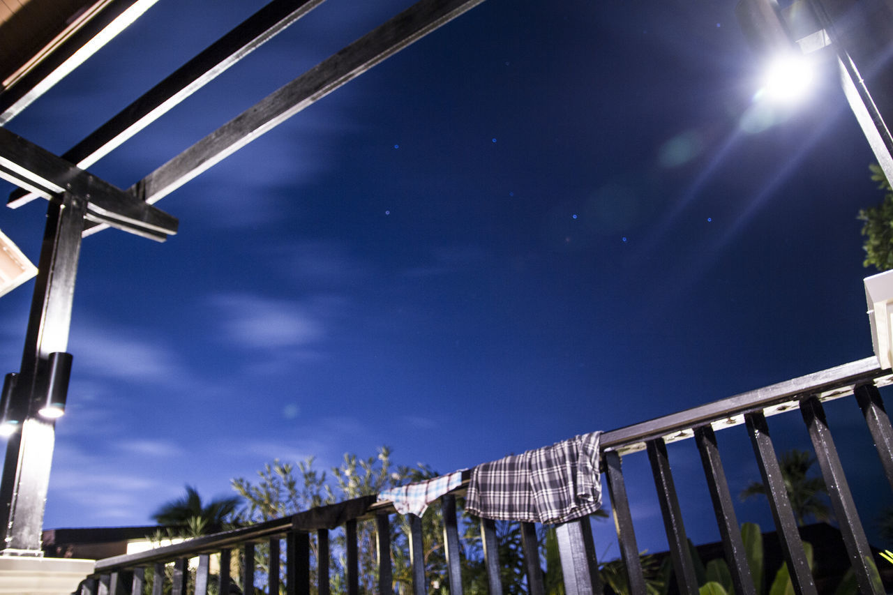 LOW ANGLE VIEW OF ILLUMINATED BRIDGE AGAINST SKY