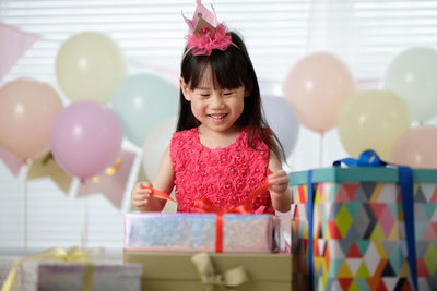 Portrait of a smiling girl with balloons