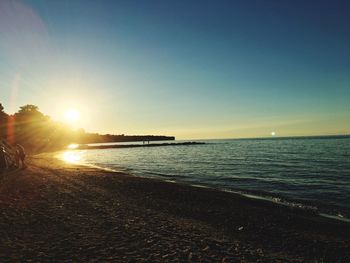 Scenic view of beach against clear blue sky